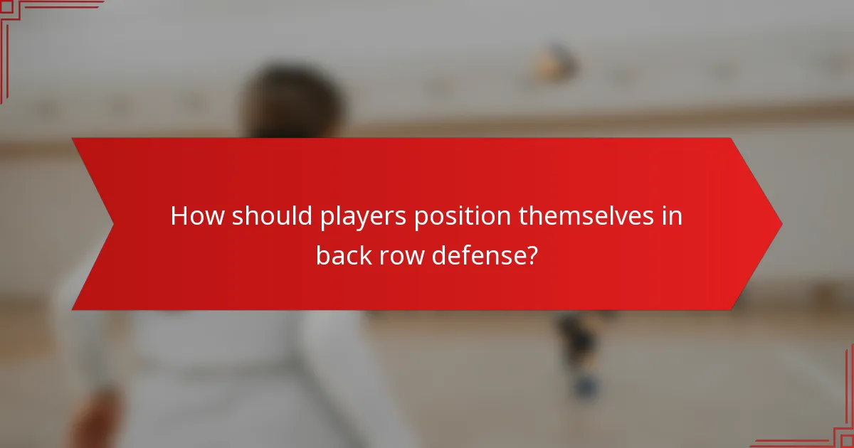 How should players position themselves in back row defense?